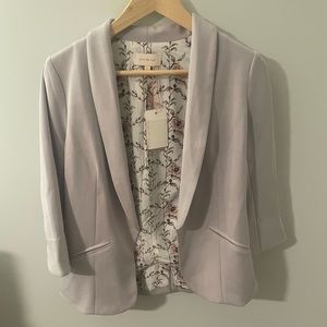 New with tags, pale grey/ tan jacket with pleat in back and pockets